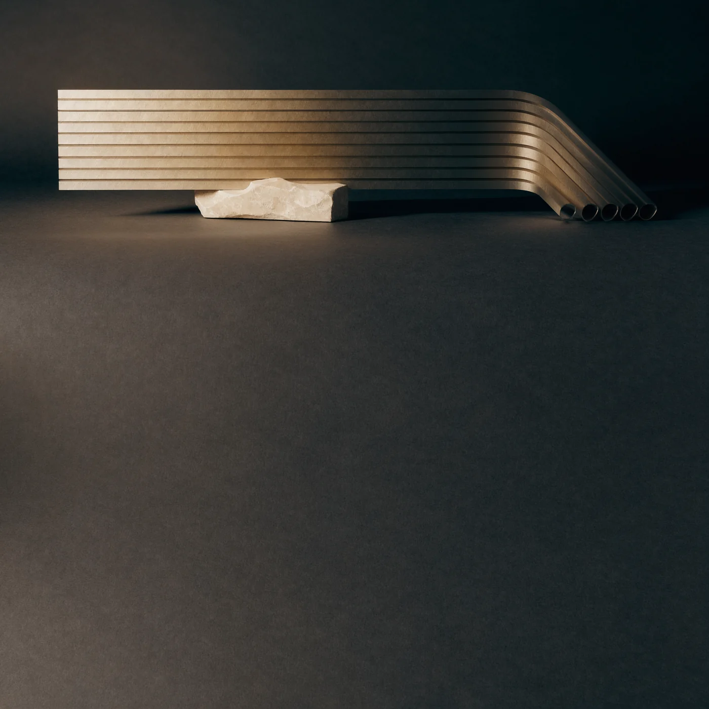 Parallel brushed-metal channels curve over a pale stone support in warm light.